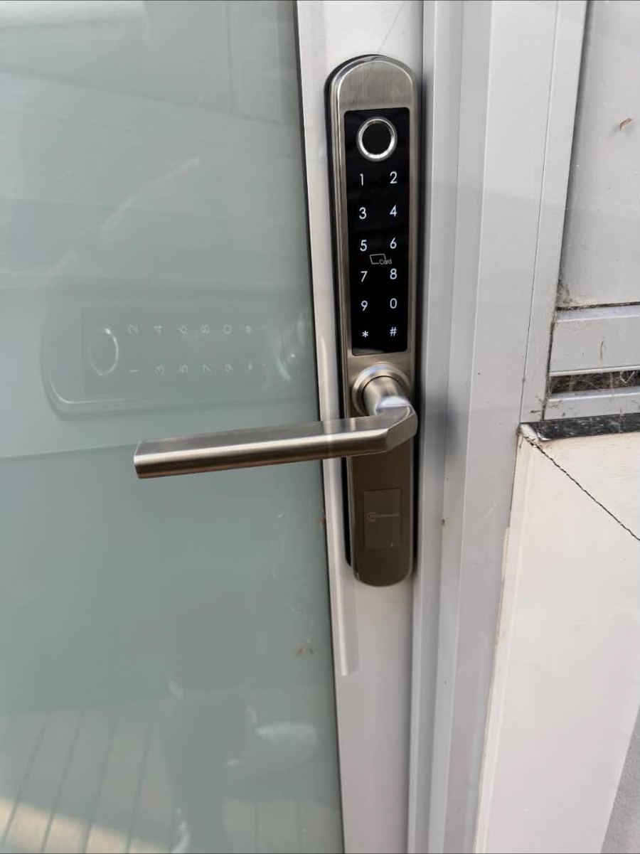 Fingerprint and keypad smart lock on a glass door